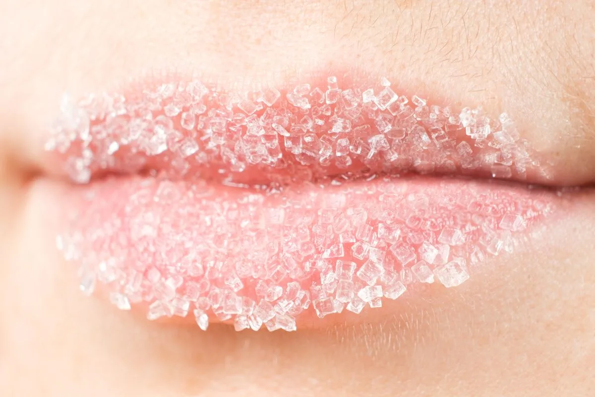 a close up of pink lips with sugar scrub on them