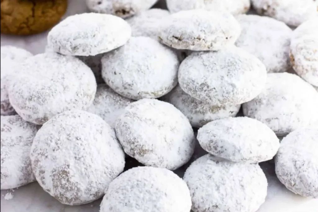 Powdered sugar–dusted Pfeffernüsse spice cookies, traditional winter wishing biscuits.